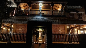 A traditional building with a wooden balcony, brick walls, and a decorative entrance. - Apla Wada (Khandala)