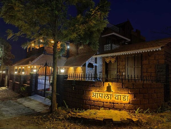 Experience the charm of Apala Wada, a traditional building with a brick facade and tiled roof, offering a warm and inviting atmosphere.