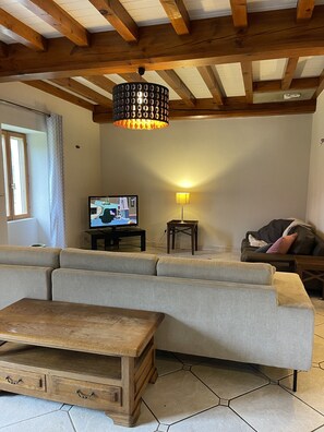 Relax in this inviting space with a comfortable sofa, wooden coffee table, and floor lamp.