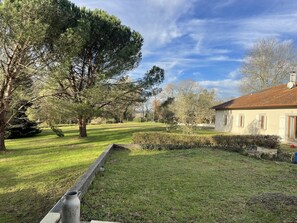 Surrounded by lush trees, this serene property features a charming traditional-style building.