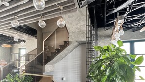 A modern interior with a staircase, hanging light fixtures, and potted plants. - Agarwood Villa - Beach and Pool Phu Quoc (Phu Quoc)
