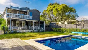 A two-story house with a covered patio and a swimming pool. - The Birkdale by Ready Set Stay- heated pool, WIFI, amazing and modern (Sunset Strip)