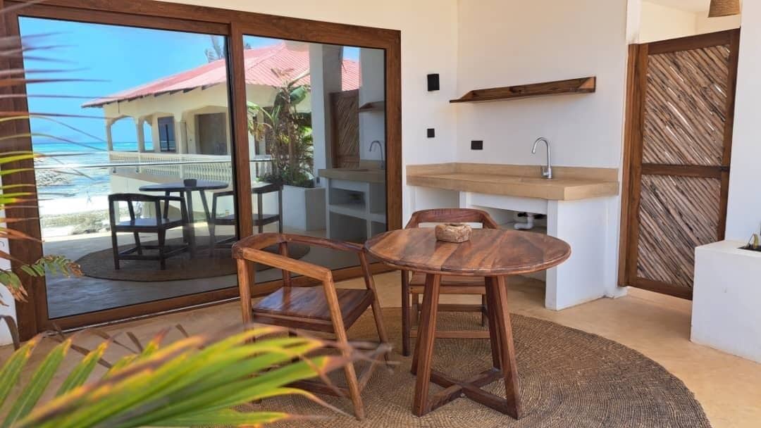 A compact kitchen with a sink and a wooden dining table.