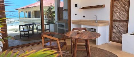A compact kitchen with a sink and a wooden dining table.