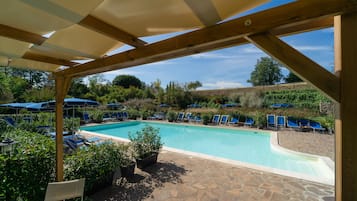 Seasonal outdoor pool, open 9:00 AM to 7:00 PM, pool umbrellas