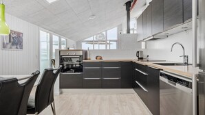 A modern kitchen with a built-in oven, a dishwasher, and a sink with a faucet. - Nice home in Hvide Sande with sauna (Hvide Sande)