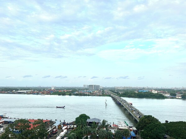 A river with a bridge, boats, and buildings in the background.