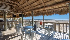 A beachside restaurant with a thatched roof, outdoor seating, and a view of the beach. - Amazing 1-bd Beach Villa, best location Hilton Head Island -Heart of the Island! (Hilton Head Island)