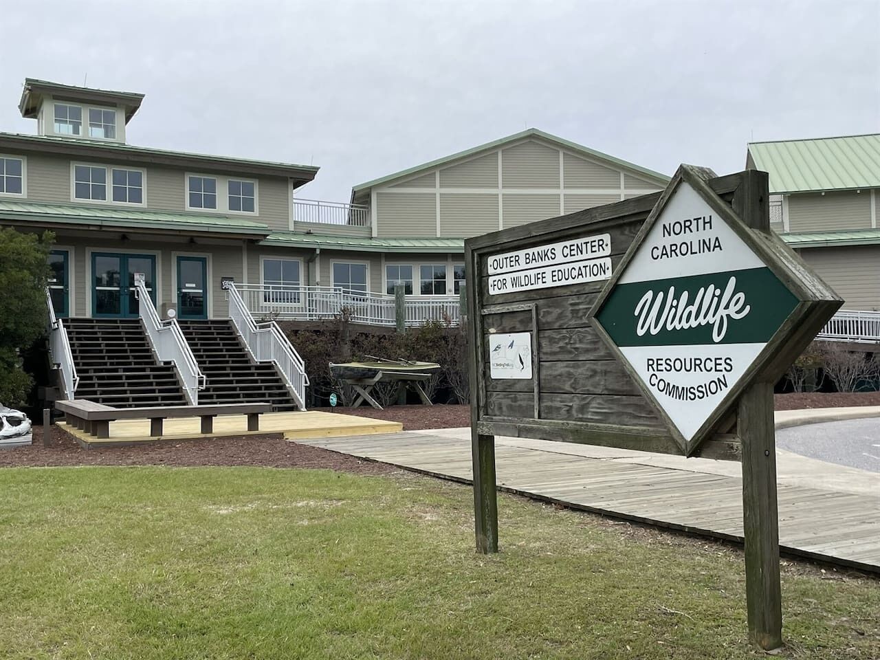 A building with a sign for the Outer Banks Center for Wildlife Education and North Carolina Wildlife Resources Commission.