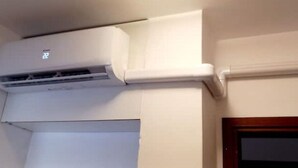 An air conditioning unit mounted on a wall with a window below it. - 2 Bedroom Apartment in Pisa (Pisa)