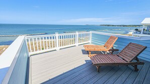 A wooden deck with two lounge chairs overlooking a beach. - Gorgeous New 5 BDR, 4 BA Beach Home With Tower Outlook Suite! (Cape Charles)