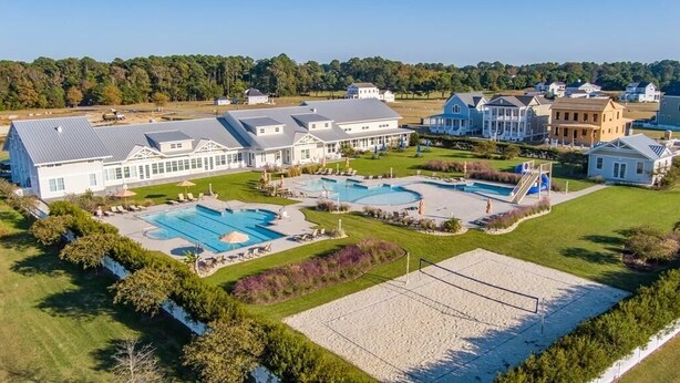 A residential area with multiple houses, a large swimming pool, and a tennis court. - Gorgeous New 5 BDR, 4 BA Beach Home With Tower Outlook Suite! (Cape Charles)