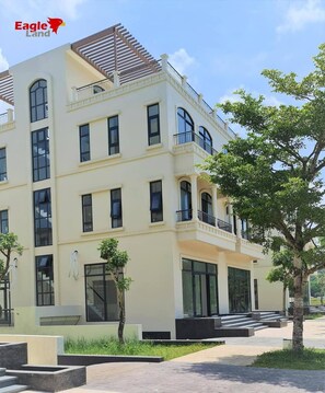 A multi-story building with balconies, large windows, and a flat roof. - Palmera Villa Phu Quoc (Phu Quoc)