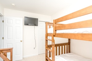 A bunk bed with a television mounted on the wall above it. - The Salty Beagle - 4BR Home with Pool; Ocean & Sound Views (Surf City)