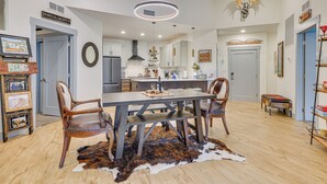 A spacious kitchen with a large island, wooden chairs, and a cowhide rug. - Downtown Winter Park Condo ~ 3 Mi to Skiing! (Winter Park)