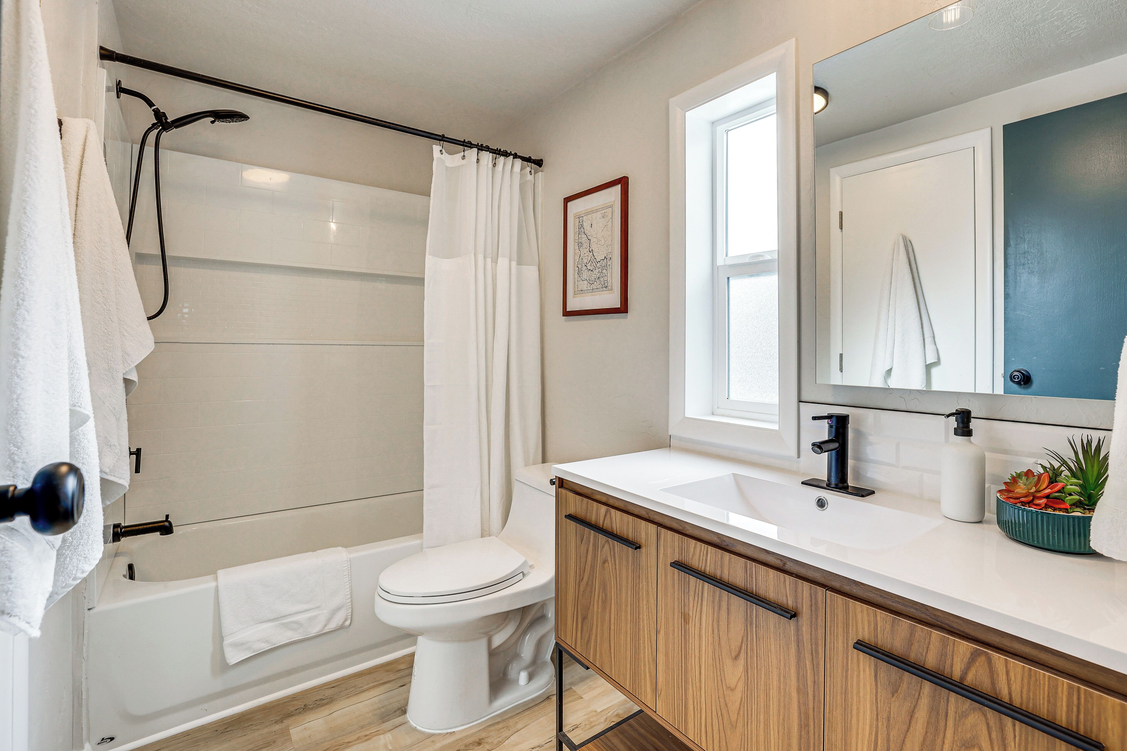 A modern bathroom with a bathtub, toilet, and sink.