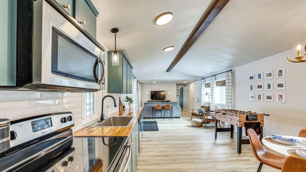 A modern kitchen with stainless steel appliances, wooden countertops, and a central island with seating. - Downtown Cascade Vacation Rental < 1 Mi to Lake! (Cascade)