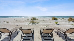 A beach view with four lounge chairs facing the ocean. - Las Hermanas 1 Studio by RedAwning (Longboat Key)