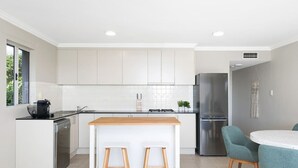 A modern kitchen with white cabinets, a wooden countertop, and a stainless steel refrigerator. - Panoramic views, 5-bedroom waterfront (Sylvania)