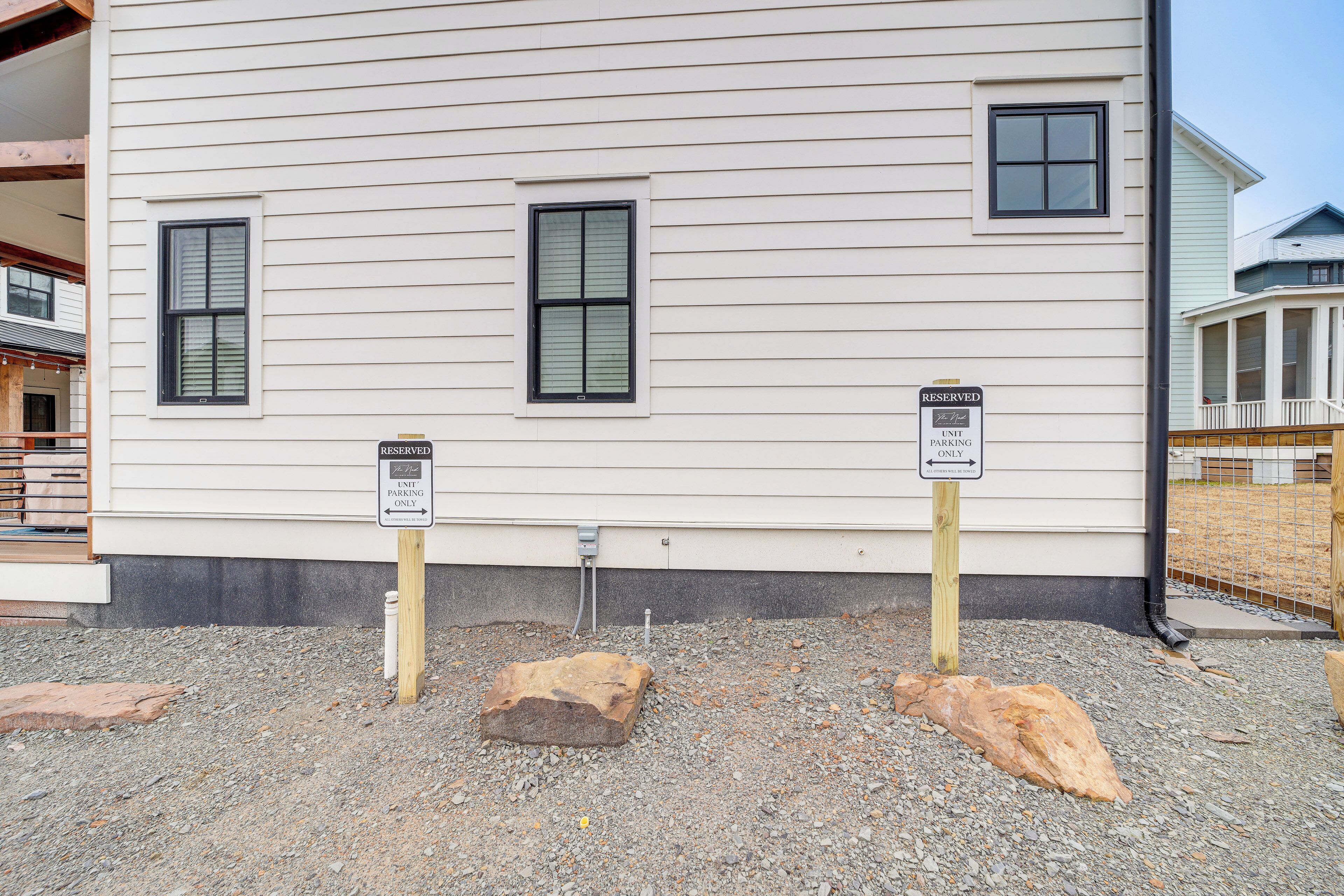 A building with two signs indicating reserved parking and unit parking only.
