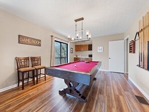 Billiards and a wet bar in game room.