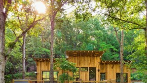 A wooden cabin with a deck, surrounded by trees. - Sugar Shack - Blue Ridge GA (Blue Ridge)