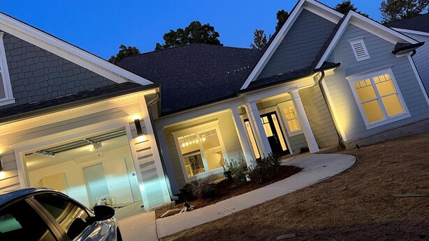 A residential house with a garage, a covered porch, and a driveway.