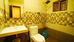A bathroom with a sink, toilet, and shower.