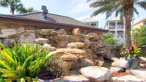 A stone waterfall feature with surrounding rocks and potted plants. - ☀️Pet Friendly-1 Block to Lagoon Community Pool-4BR Southern Comfort VCB☀️ (Destin)