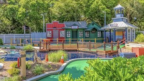 A miniature harbor scene with a green building labeled "Harbor Marine Supplies," a red building, and a blue structure labeled "Harbor Master." - The Nautical Nook Beach Cottage - #1714 Ocean Lakes (Myrtle Beach)