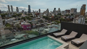 A rooftop pool with lounge chairs, a cityscape view, and a clear sky. - Milenia Soho by iPPA (Buenos Aires)