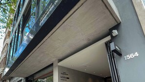 A modern building with a glass facade, a visible entrance, and a sign for 'Bar Café'. - Milenia Soho by iPPA (Buenos Aires)