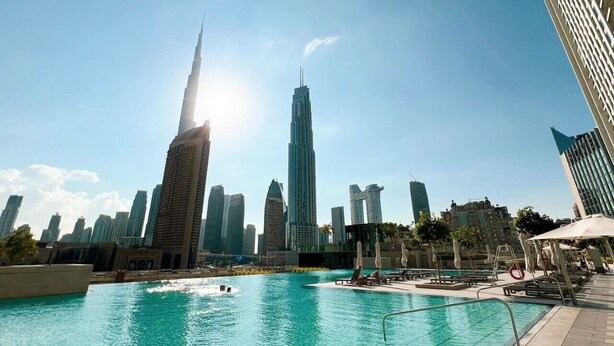 A pool area with a view of the Burj Khalifa and other high-rise buildings.
