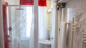 A bathroom with a shower, sink, and towel rack. - CA RIZZARDI (Mestre)