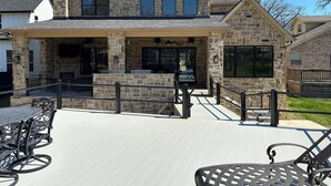 A stone house with a covered patio, outdoor seating, and a fireplace. - New Lake Paradise! 4 bdrm 3.5 ba house w/ lift, deck, grill, sauna, smart, media (Tool)