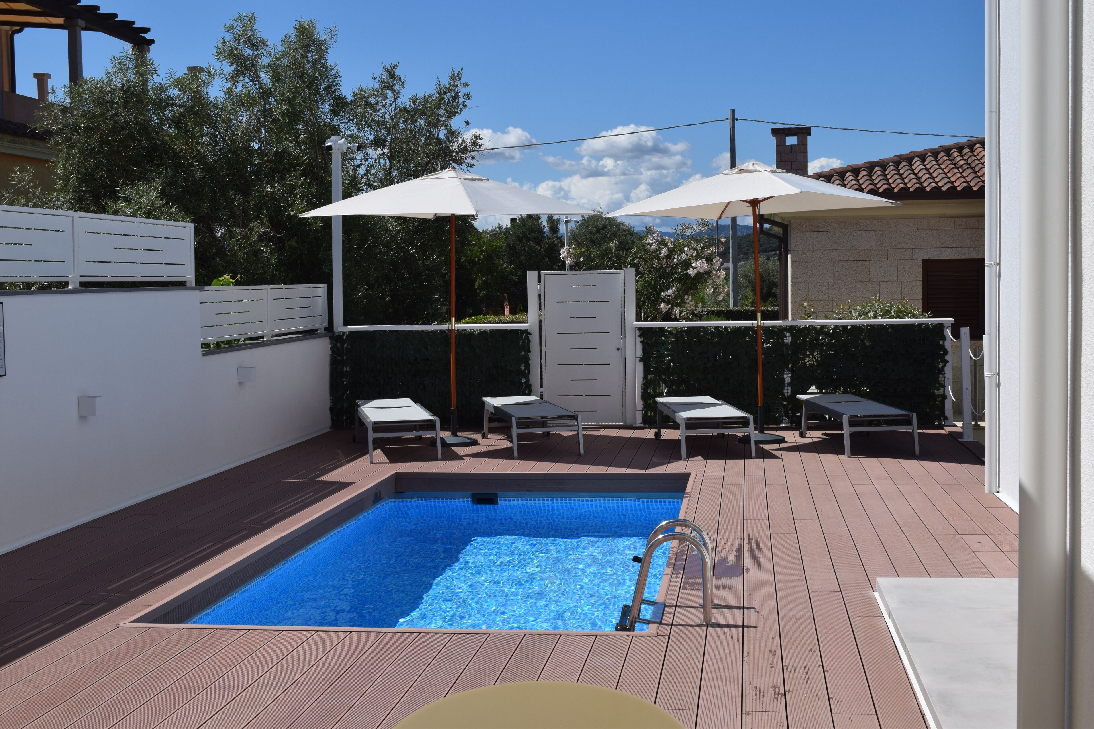 Seasonal outdoor pool, pool umbrellas, pool loungers