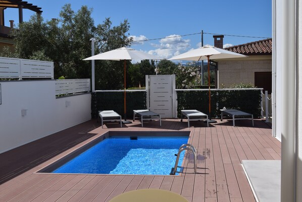 Seasonal outdoor pool, pool umbrellas, pool loungers