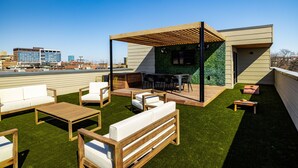 A rooftop patio with outdoor furniture, a pergola, and a view of the city skyline. - Rooftop Terrace Near Downtown Fort Worth (Fort Worth)