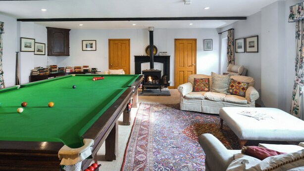 A pool table in a room with a sofa, a fireplace, and framed pictures on the wall. - 2 bedroom accommodation in Quadford, near Bridgnorth (Quadford, near Bridgnorth)