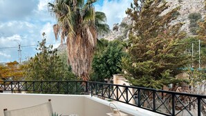 A balcony with a table set for breakfast, including croissants, orange juice, and coffee. - Theonia Villas (Pefki)
