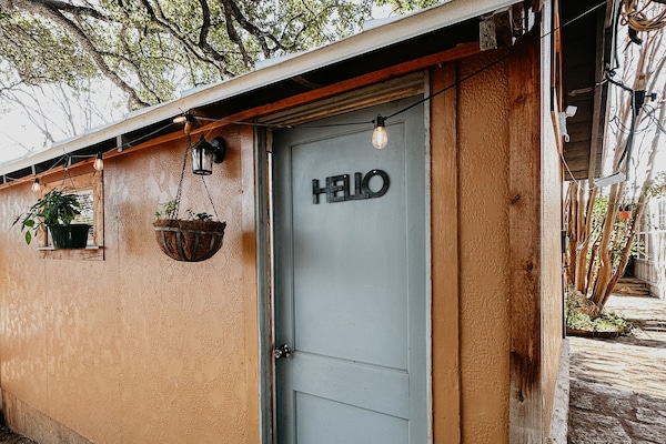Side entrance to Carriage House facing the private patio w/ fire pit.