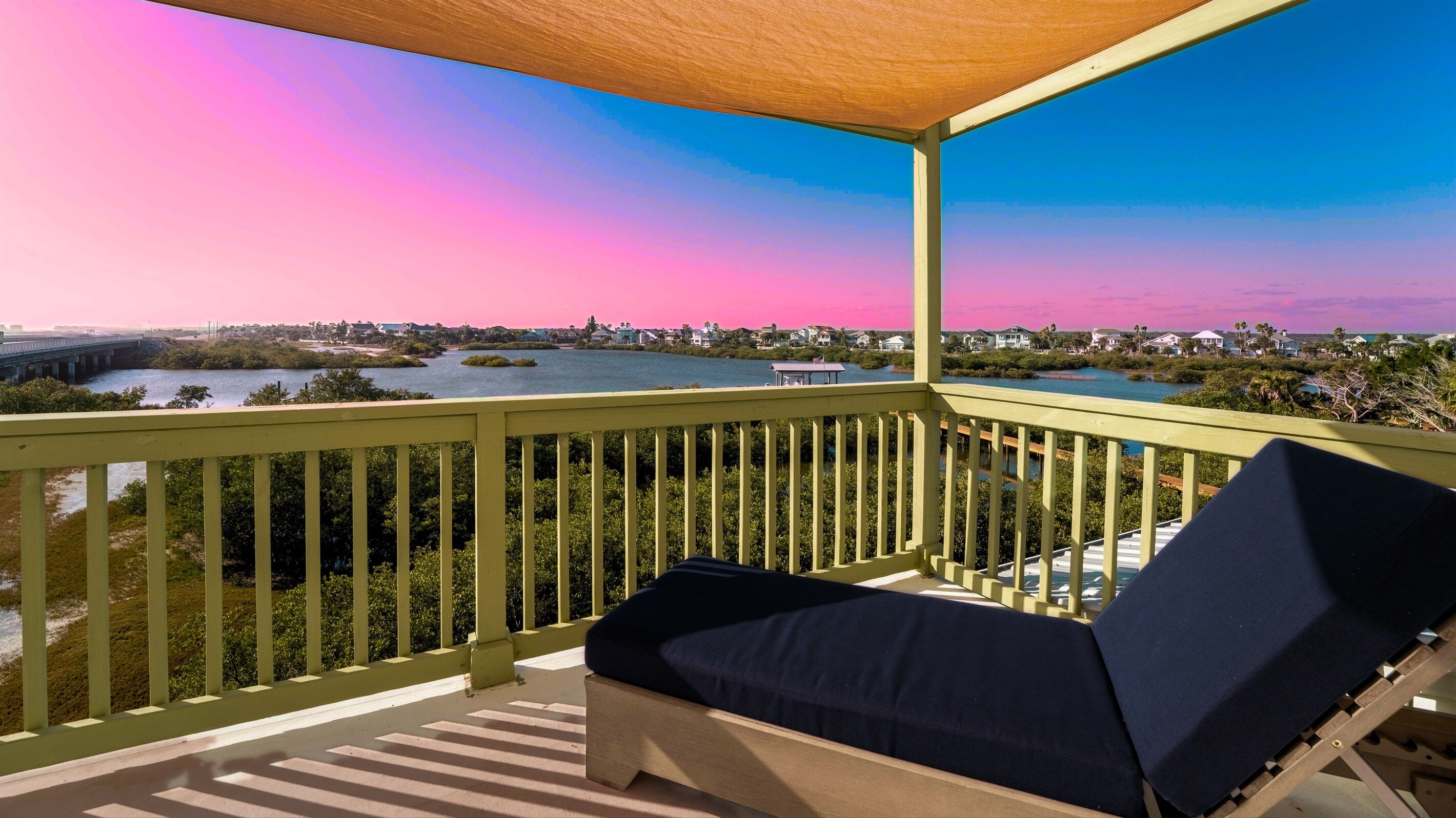 Sun-sail shaded sitting area perfect for morning coffee or evening breezes.