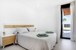 A modern bedroom with a bed, nightstand, and a view of the outside.