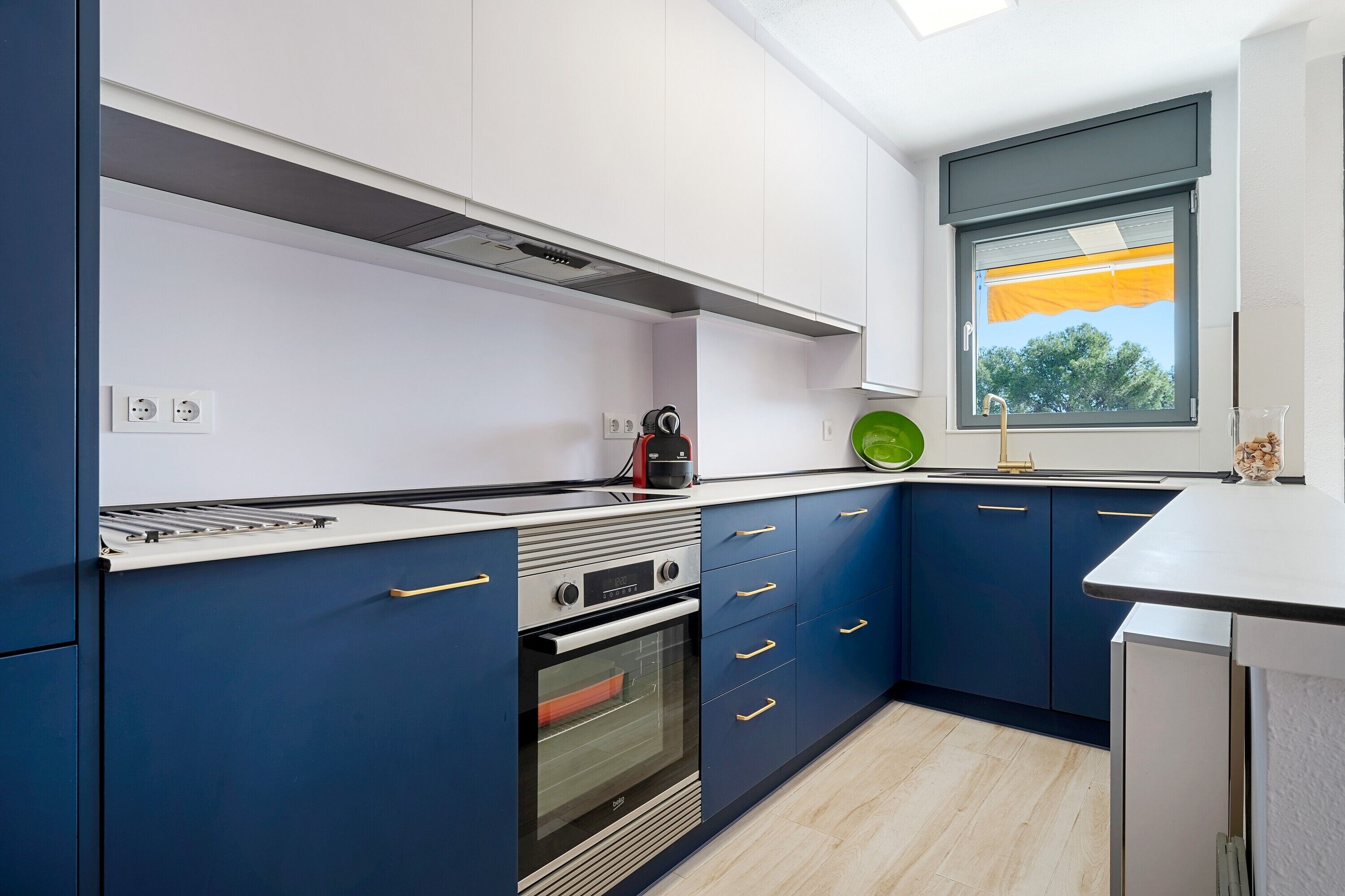A modern kitchen with a built-in oven, a microwave, and a gas stove.