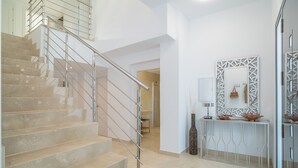 A staircase with a metal handrail leading to a landing. - Villa 'Jazmin' with Mountain View, Wi-Fi and Air Conditioning (Mijas Costa)