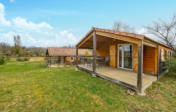 A wooden cabin with a covered porch and a patio area. - Beautiful home in Barjac with WiFi (Barjac)
