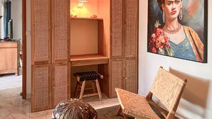 A room with a wooden cabinet, a small stool, a chair, and a painting on the wall. - Luxurious home in Mouries with private swimming pool, can be inside or outside (Mouries)
