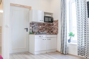 Mikrobølgeovn, kogeplade, brødrister, køkkentøj/tallerkener/redskaber