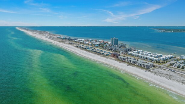 An aerial view of a coastal resort with beachfront properties, a marina, and a pier. - Boardwalk A4 | Pool, Beach Access | New Renovations! (Pensacola Beach)