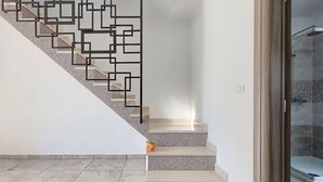 A staircase with a geometric metal railing, leading to a room with a shower area. - Stunning home in Labin (Labin)